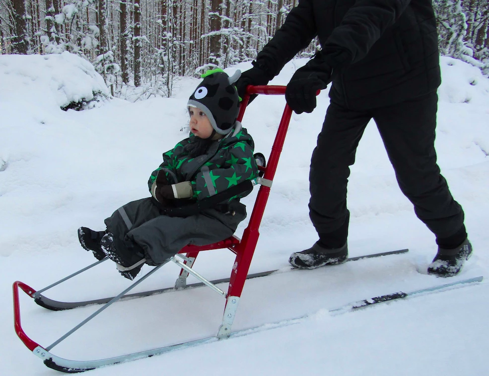 A child on a spark with a man standing on it